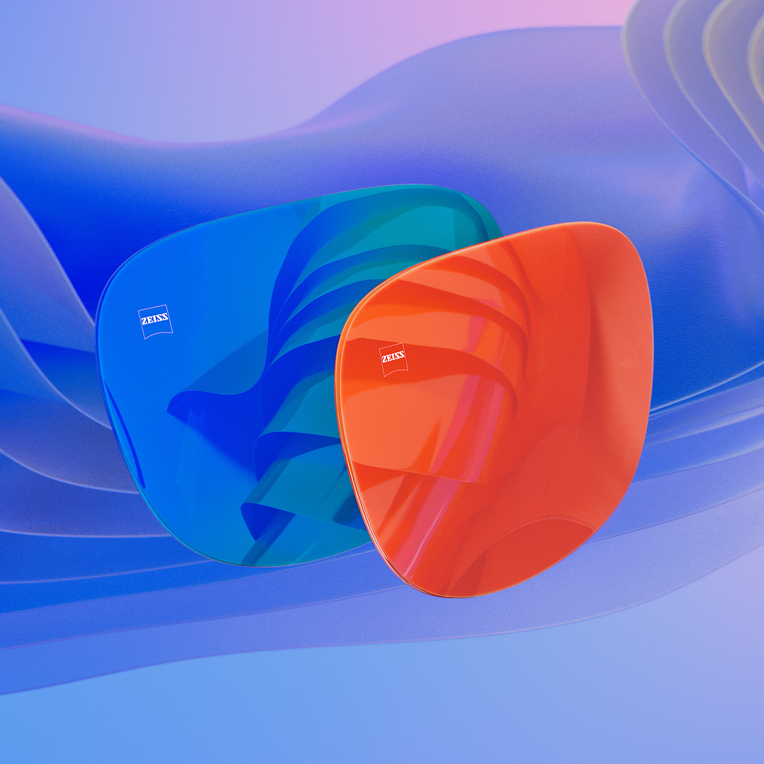 3D CGI -havainnekuva kahdesta aurinkolasilinssistä, joissa on sininen ja oranssi peilipinnoite.