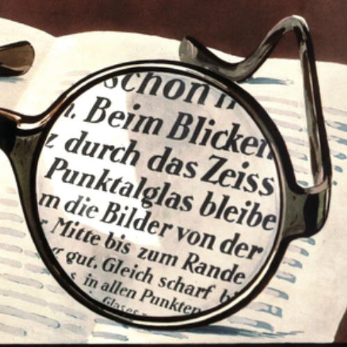 Kuva vanhasta ZEISS Punktal -linssien mainoksesta, jossa näkyy selkeä näkymä koko linssin läpi. Tämä oli vallankumouksellista vuonna 1912. 